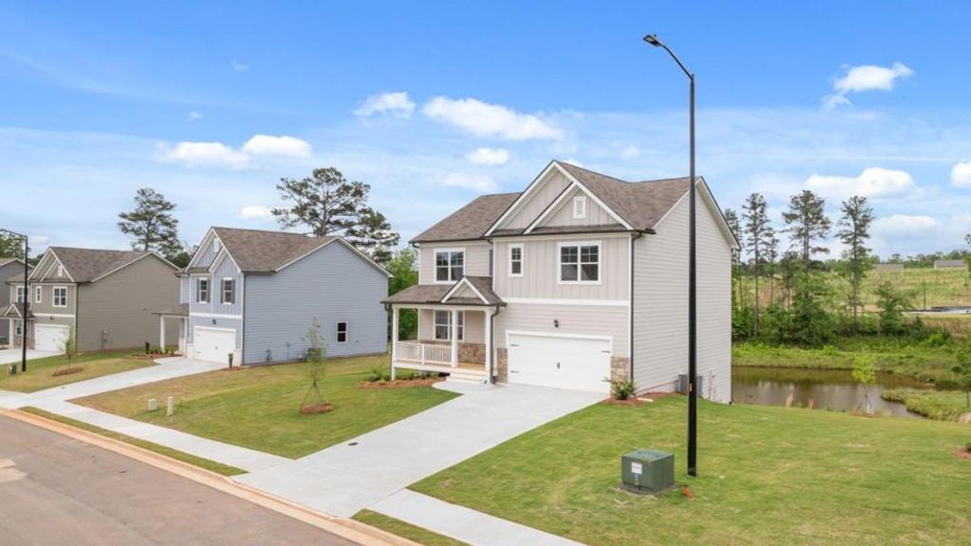 Front exterior of a new home in Thompson Ridge, Dallas, GA, highlighting curb appeal (Image 2). Front exterior of a new home in Thompson Ridge, Dallas, GA, highlighting curb appeal (Image 2).