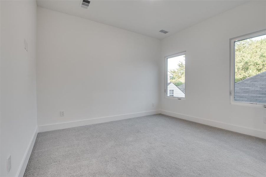 Unfurnished room with light carpet and baseboards