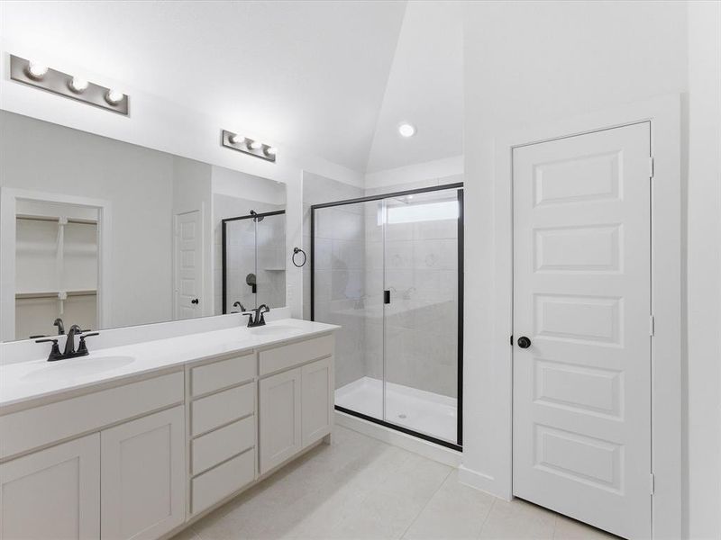 Dual vanity with white cabinetry and countertops, matte black hardware, and oversized mirror Dual vanity with white cabinetry and countertops, matte black hardware, and oversized mirror