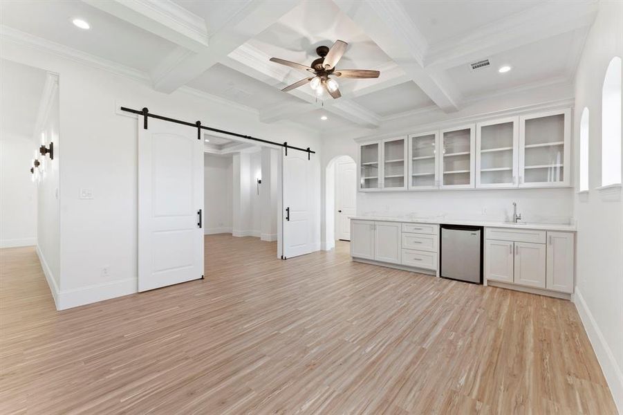 Another view to highlight the stylish barn door access to your media room. Notice the coffered ceilings. These builders did not hesitate to follow the attention to details and upgrades unto your second living spaces.