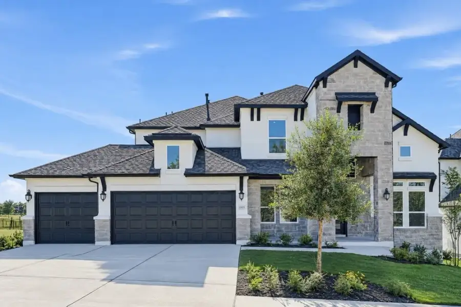 Front exterior of a new home in Travisso, Leander, TX, highlighting curb appeal (Image 17).