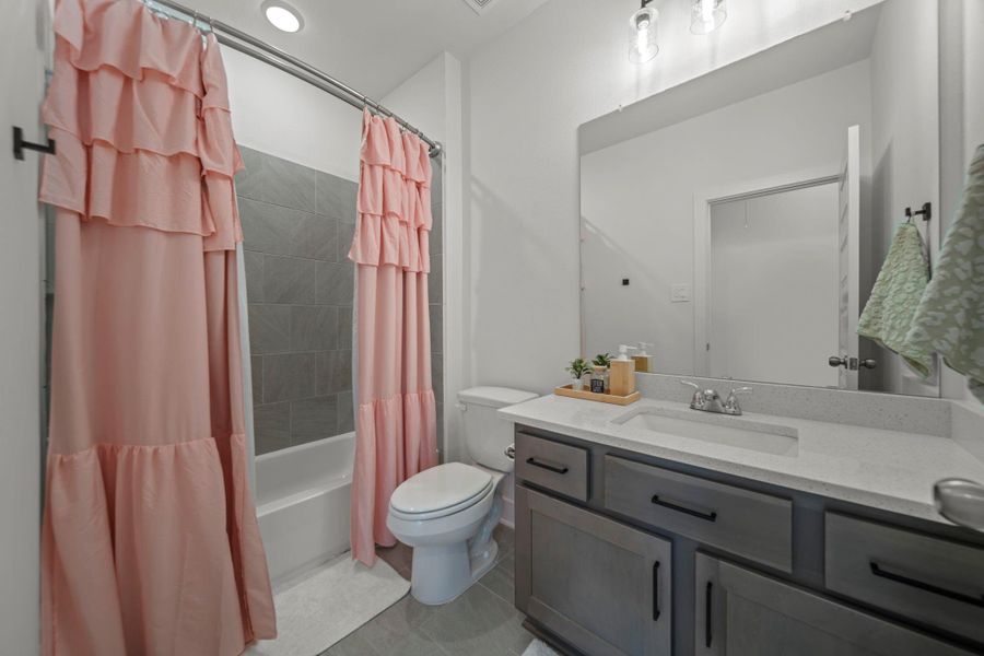 Charming hallway bath for third bedroom upstairs or guests. Neutral vanity and full tiled shower/tub. Playful details make it warm and inviting. Charming hallway bath for third bedroom upstairs or guests. Neutral vanity and full tiled shower/tub. Playful details make it warm and inviting.