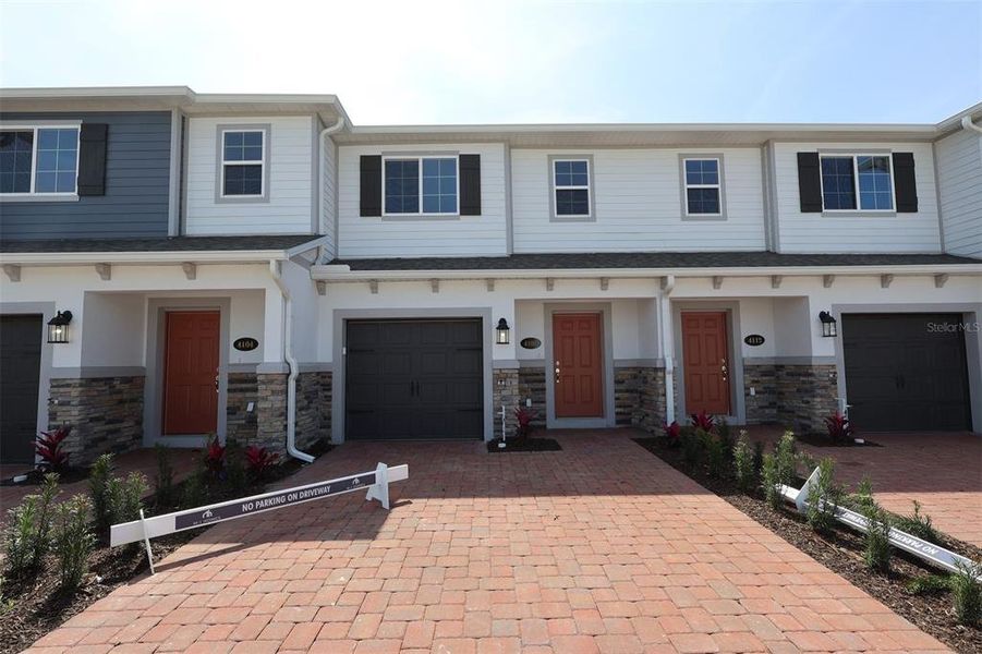 Front exterior of a new home in Tyson Ranch, Orlando, FL, highlighting curb appeal (Image 1). Front exterior of a new home in Tyson Ranch, Orlando, FL, highlighting curb appeal (Image 1).