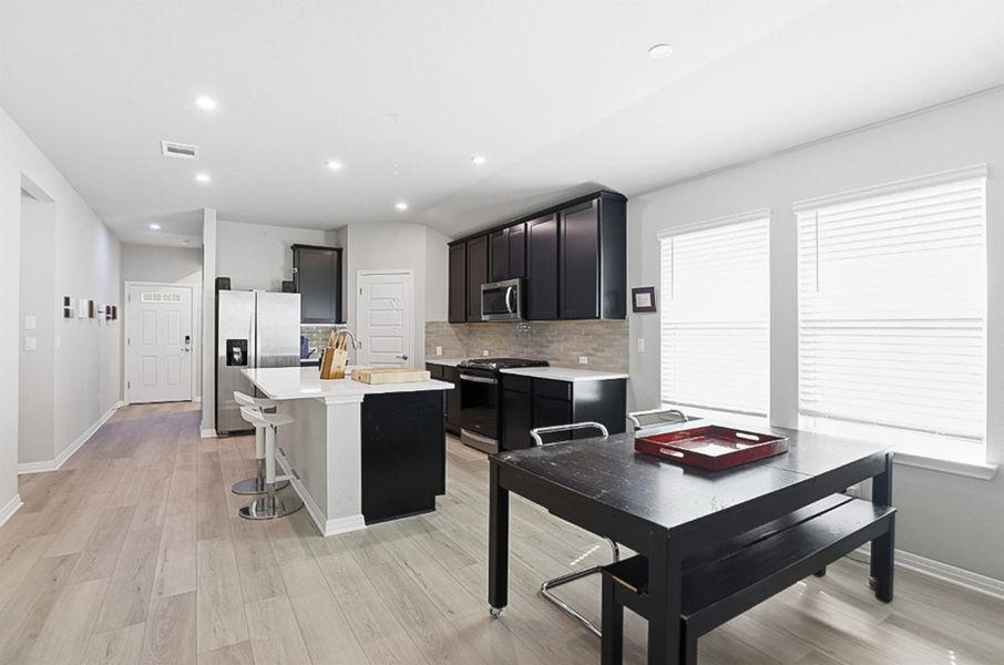 The dining area is positioned between the kitchen and living room, perfect for entertaining.