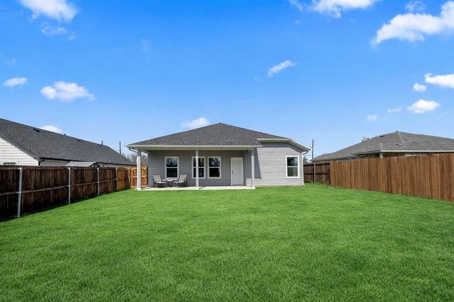 Rear view of house with a patio and a fenced backyard