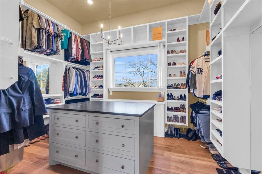 Oversized walk in closet with vanity and 12 ft ceilings