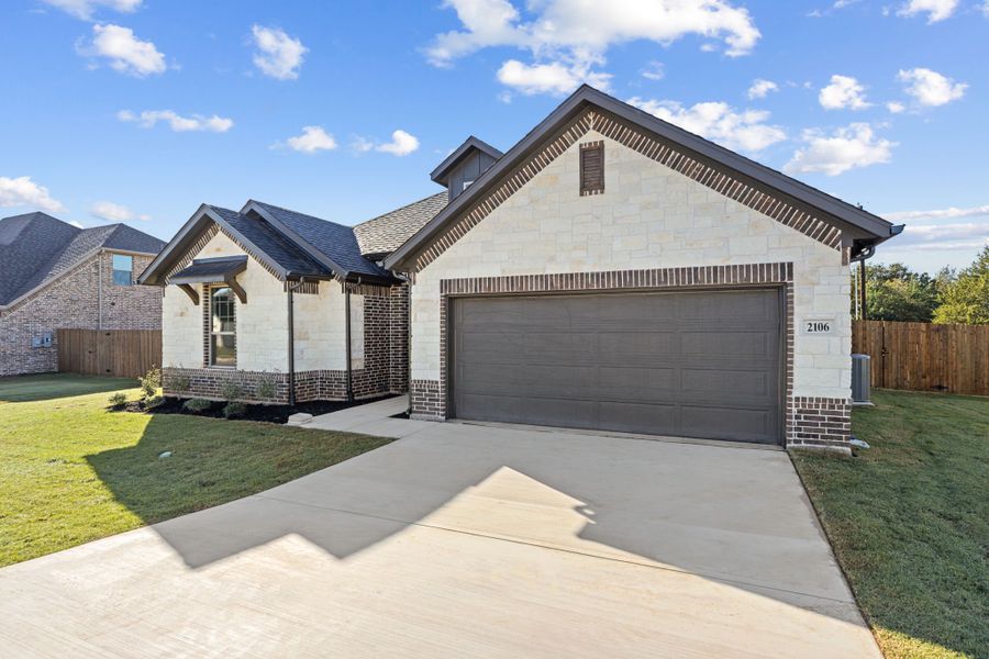 Front exterior of a new home in Fair Oaks, Bridgeport, TX, highlighting curb appeal (Image 1). Front exterior of a new home in Fair Oaks, Bridgeport, TX, highlighting curb appeal (Image 1).
