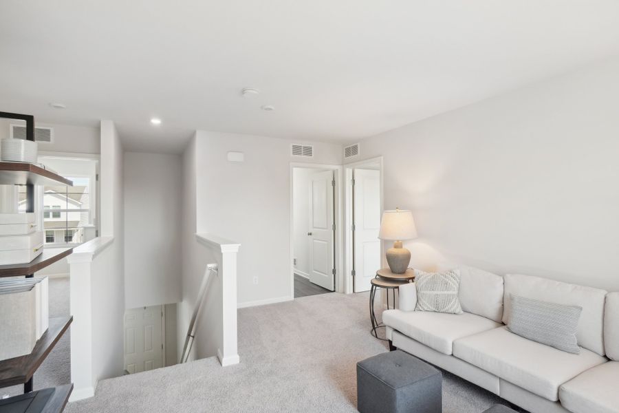 A living room with white furniture.
