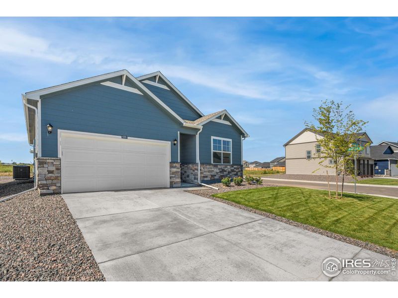 Front exterior of a new home in Tailholt, Severance, CO, highlighting curb appeal (Image 1). Front exterior of a new home in Tailholt, Severance, CO, highlighting curb appeal (Image 1).