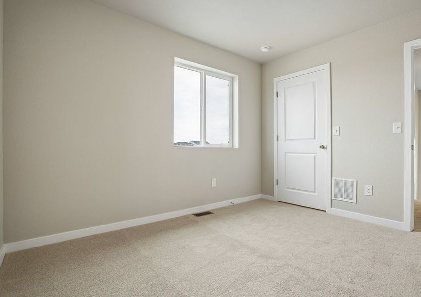 The master bedroom is spacious with a large window.