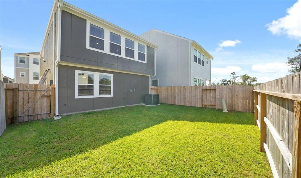 The fully fenced backyard space features beautiful green space perfect for entertaining.