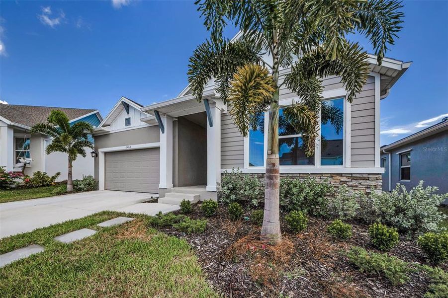 Front exterior of a new home in Eagle Creek - Garden Series, Tarpon Springs, FL, highlighting curb appeal (Image 18).