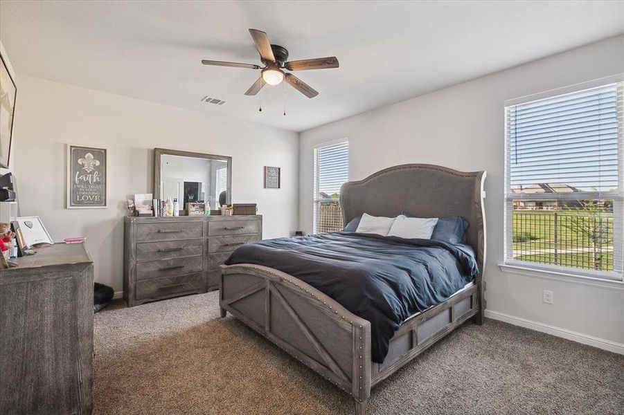 Carpeted bedroom featuring ceiling fan Carpeted bedroom featuring ceiling fan