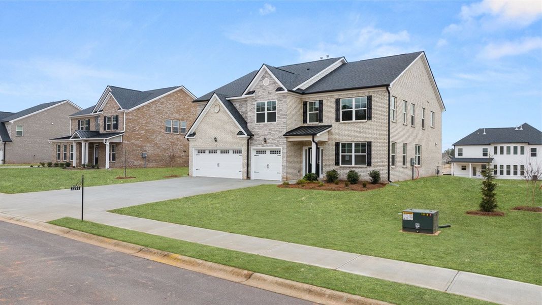 Front exterior of a new home in The Gates at Pates Creek, Hampton, GA, highlighting curb appeal (Image 23).