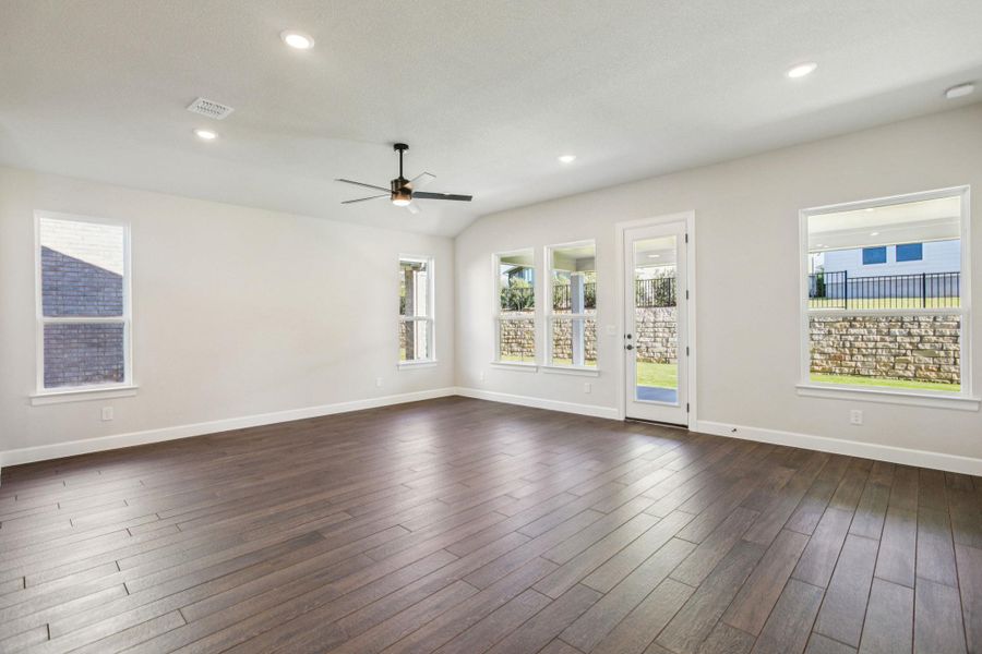 Spare room featuring recessed lighting, dark wood-style flooring, a ceiling fan, and vaulted ceiling Spare room featuring recessed lighting, dark wood-style flooring, a ceiling fan, and vaulted ceiling