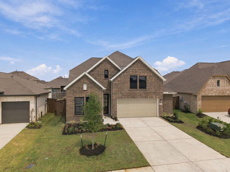 Front exterior of a new home in The Trails, New Caney, TX, highlighting curb appeal (Image 24).