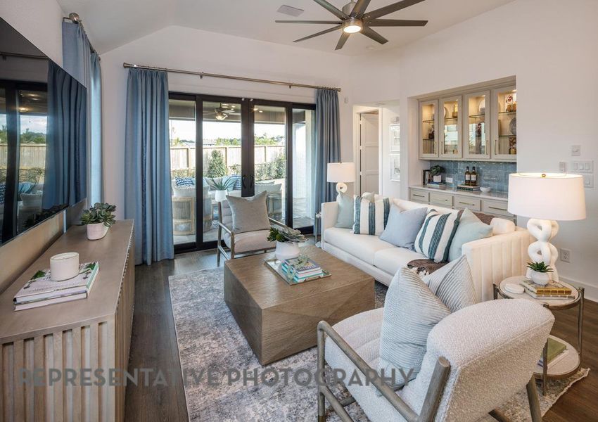 Living room featuring a ceiling fan, wood finished floors, and lofted ceiling Living room featuring a ceiling fan, wood finished floors, and lofted ceiling