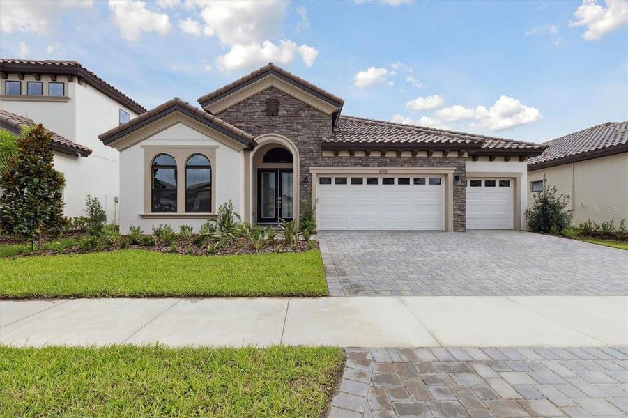 Front exterior of a new home in Hawkstone, Lithia, FL, highlighting curb appeal (Image 1).