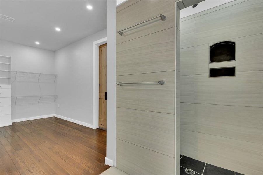 Bathroom featuring baseboards, recessed lighting, and wood finished floors