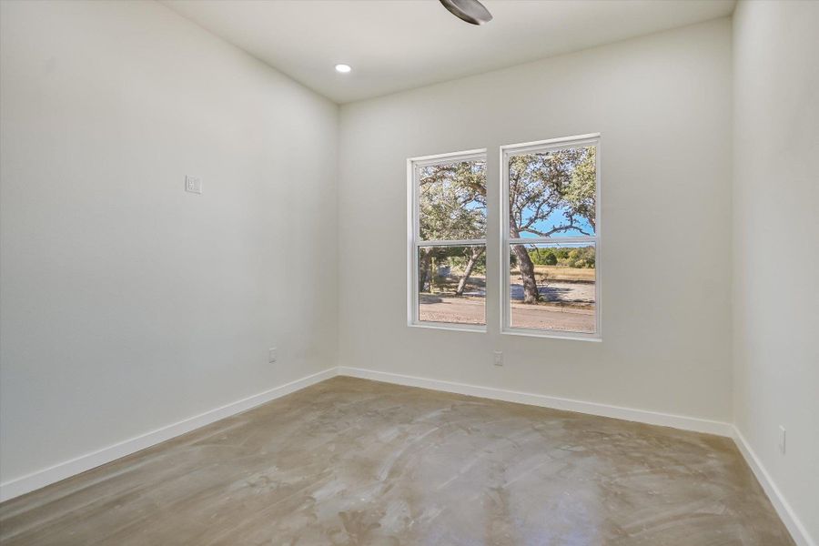 Empty room featuring concrete floors and recessed lighting
