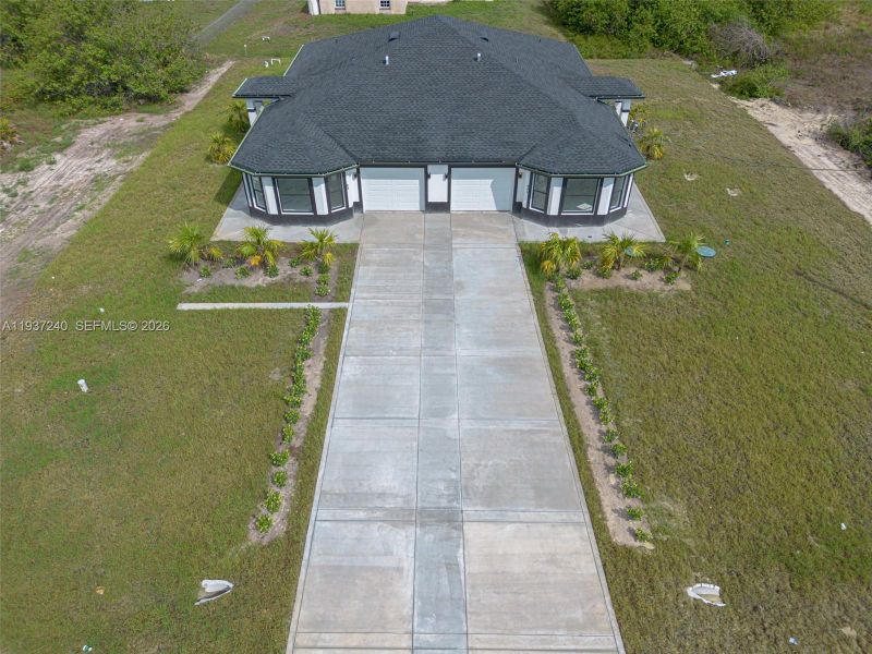 Front exterior of a new home in , Lehigh Acres, FL, highlighting curb appeal (Image 22).