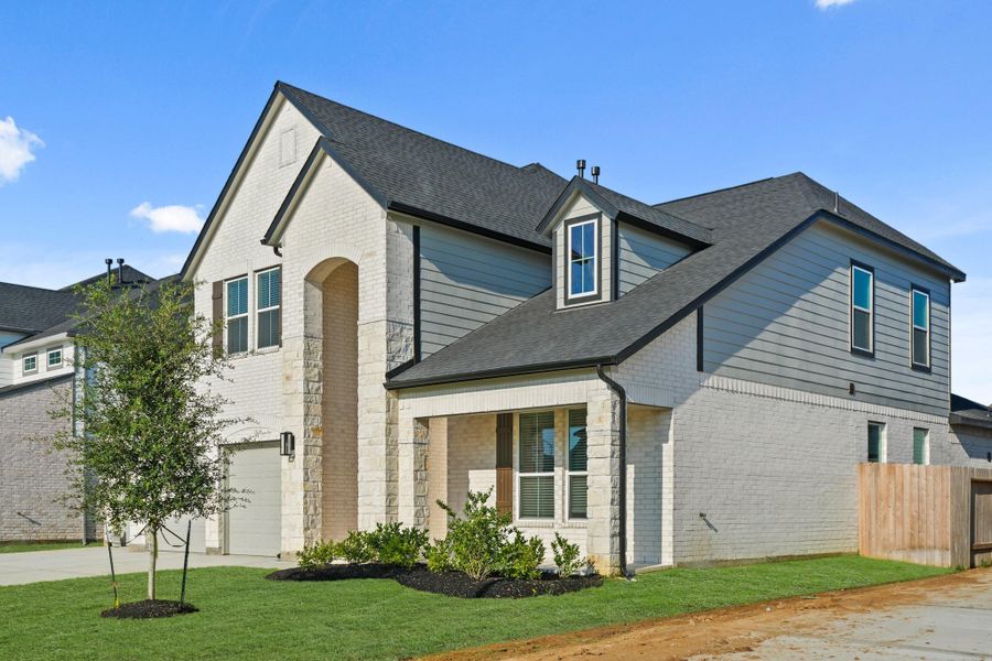 Front exterior of a new home in Beacon Hill, Waller, TX, highlighting curb appeal (Image 15). Front exterior of a new home in Beacon Hill, Waller, TX, highlighting curb appeal (Image 15).