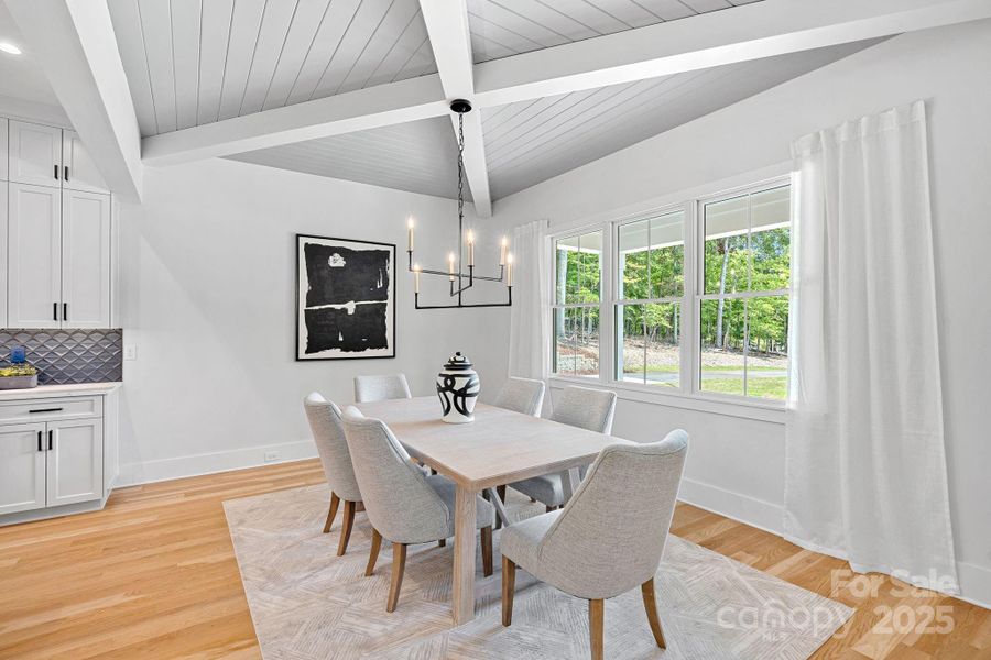 Dining area adjoining kitchen with gorgeous ceiling detailing.
