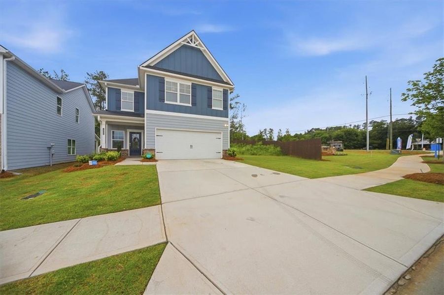 Front exterior of a new home in Fairview Lake, Conyers, GA, highlighting curb appeal (Image 25). Front exterior of a new home in Fairview Lake, Conyers, GA, highlighting curb appeal (Image 25).