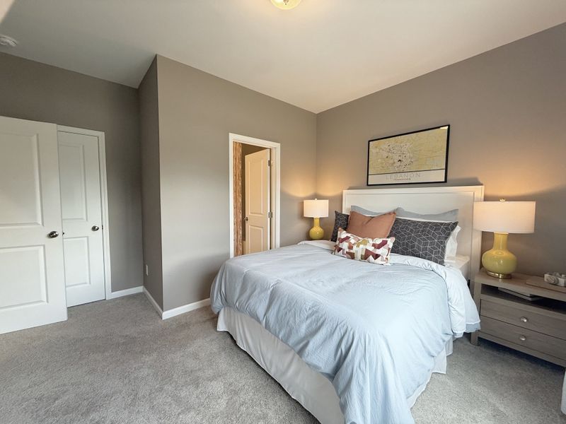 Bedroom 4 on main level with private en-suite. *Photos of model home* Bedroom 4 on main level with private en-suite. *Photos of model home*