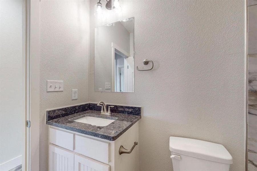 Bathroom featuring vanity and toilet