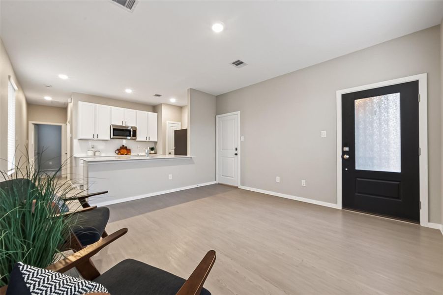 Open guest suite living area featuring recessed lighting and a bright, versatile space for relaxing or entertaining. Open guest suite living area featuring recessed lighting and a bright, versatile space for relaxing or entertaining.
