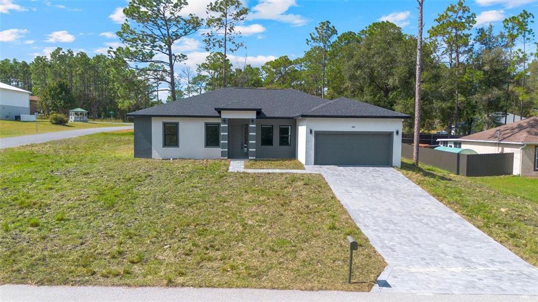 Front exterior of a new home in , Citrus Springs, FL, highlighting curb appeal (Image 21). Front exterior of a new home in , Citrus Springs, FL, highlighting curb appeal (Image 21).