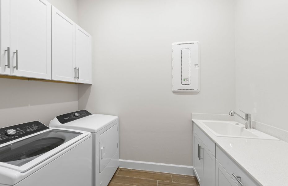 Spacious laundry room featuring additional storage space