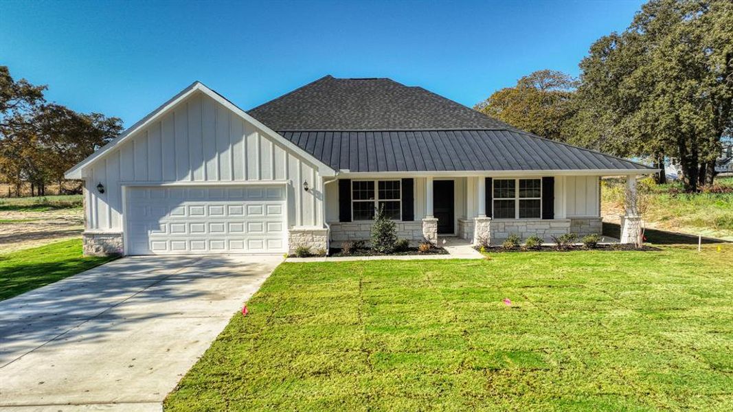 Front exterior of a new home in , Poolville, TX, highlighting curb appeal (Image 1).