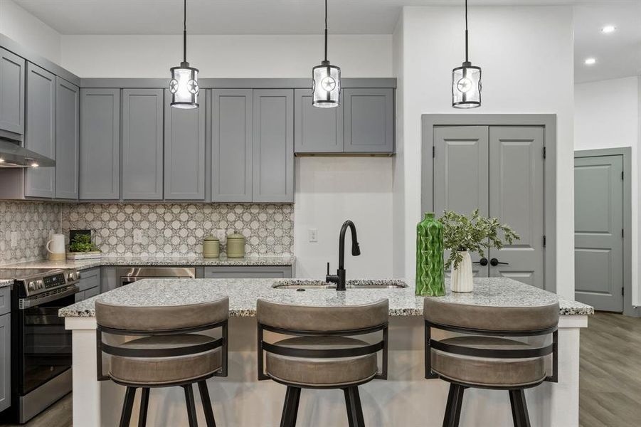 The kitchen island features pendant lighting