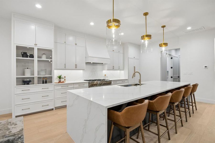 Stunning chef’s kitchen with expansive waterfall island, custom cabinetry, and premium appliances, designed for both everyday living and entertaining. Stunning chef’s kitchen with expansive waterfall island, custom cabinetry, and premium appliances, designed for both everyday living and entertaining.
