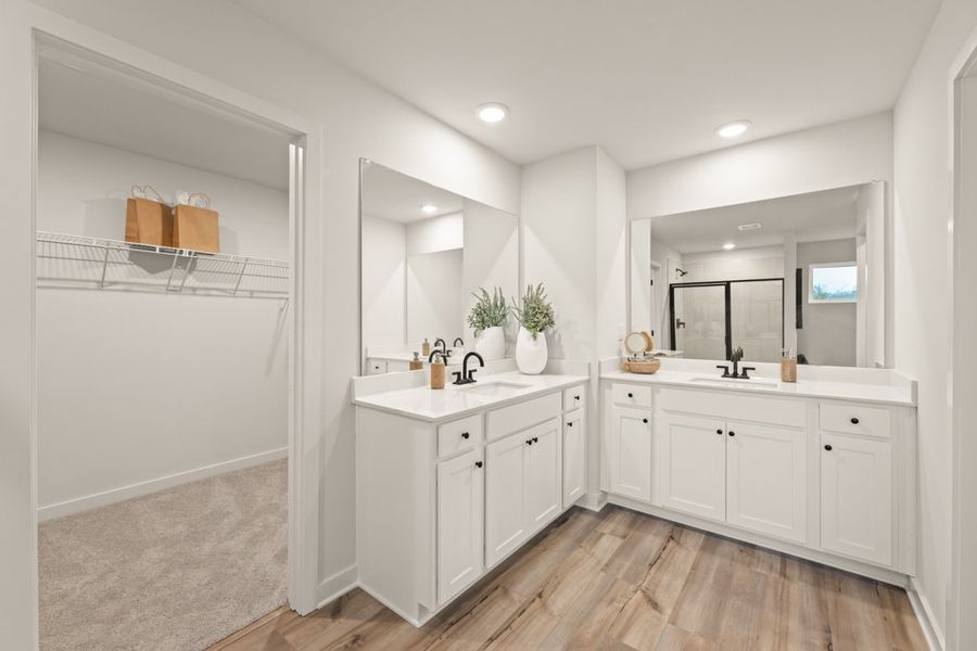 A bathroom with white cabinets.