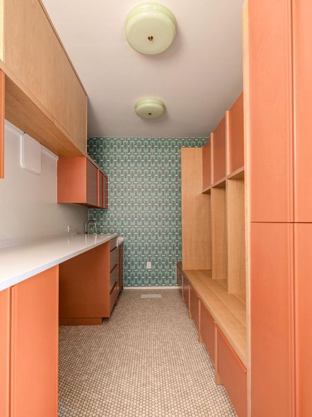 Kitchen with wallpapered walls and light countertops