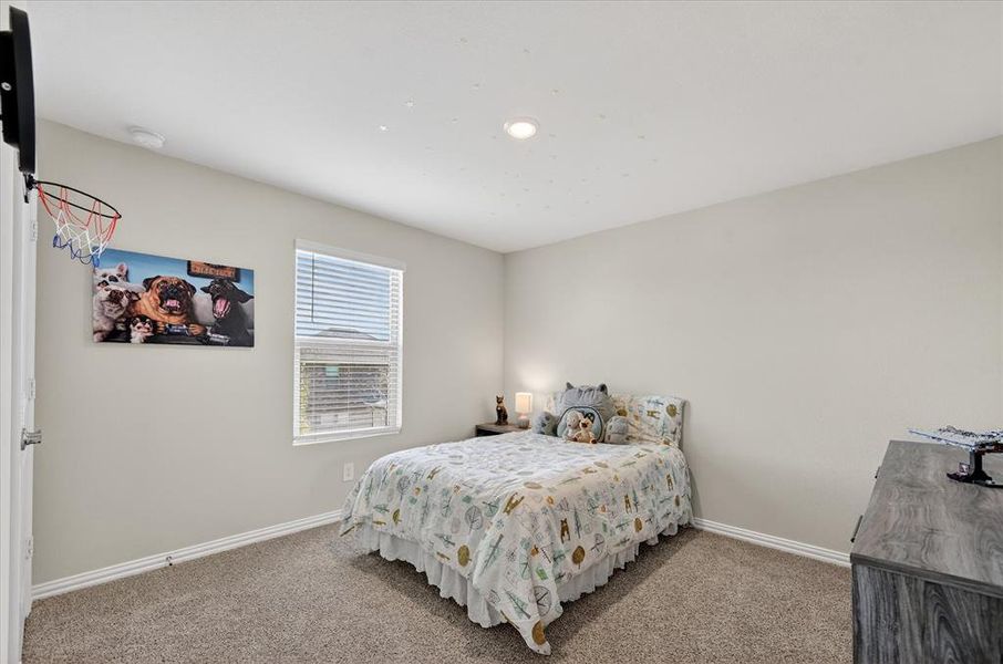 Carpeted bedroom featuring baseboards