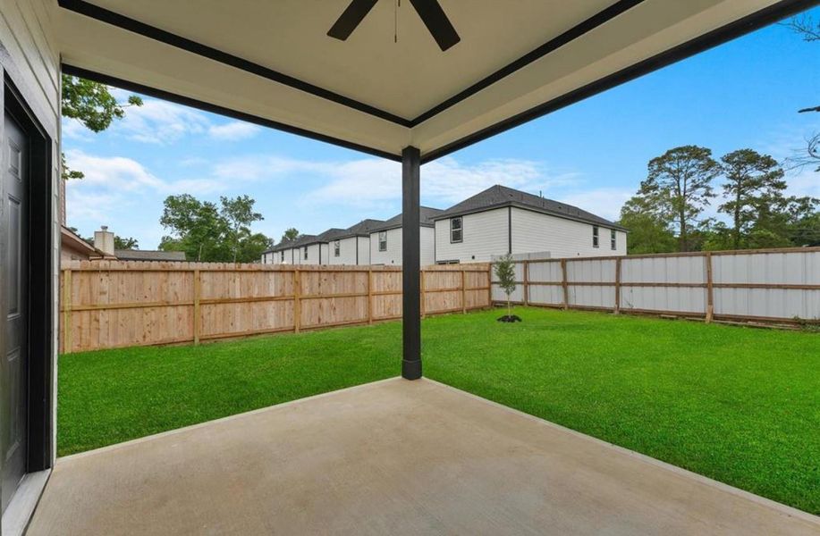 Covered backyard patio overlooking a spacious fenced backyard, perfect for outdoor relaxation and entertaining. Covered backyard patio overlooking a spacious fenced backyard, perfect for outdoor relaxation and entertaining.