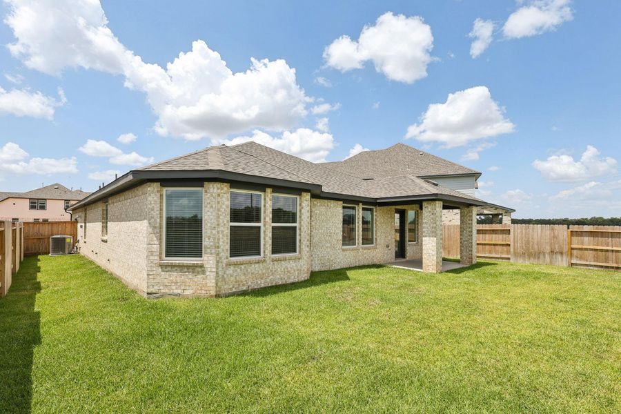 Front exterior of a new home in Kingdom Heights, Rosenberg, TX, highlighting curb appeal (Image 22). Front exterior of a new home in Kingdom Heights, Rosenberg, TX, highlighting curb appeal (Image 22).