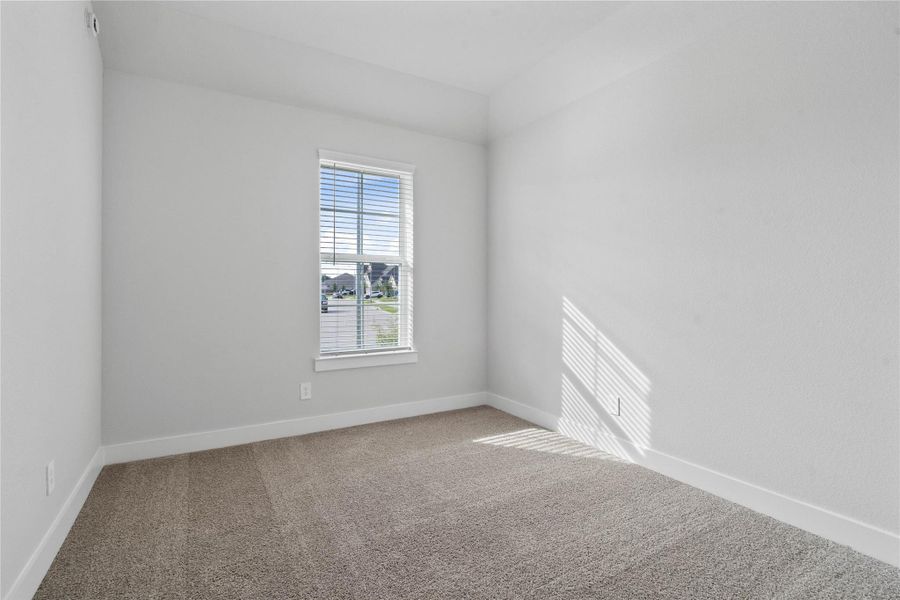 Step into this bright and airy secondary bedroom! It offers a tranquil space to unwind. The large window illuminates the room's sloped ceiling and neutral tones, creating a cheerful and airy environment. Room features a walk-in closet!