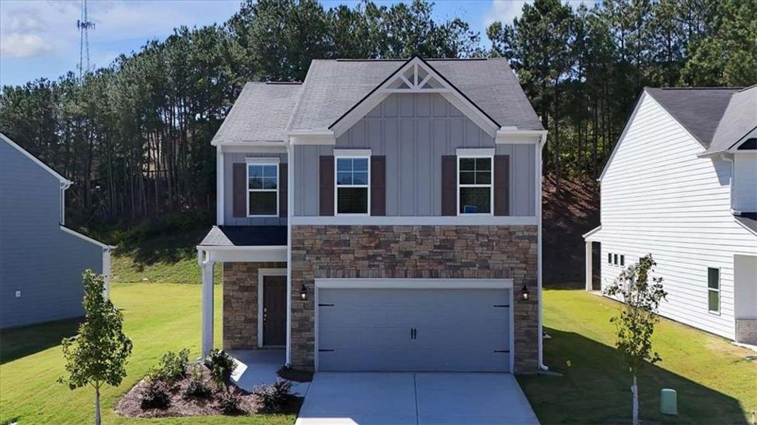 Front exterior of a new home in The View at Groover's Lake, Lithia Springs, GA, highlighting curb appeal (Image 1).
