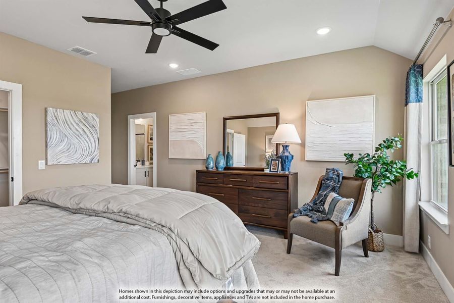 Bedroom with vaulted ceiling, ceiling fan, wood dresser, and ensuite bathroom door visible Bedroom with vaulted ceiling, ceiling fan, wood dresser, and ensuite bathroom door visible