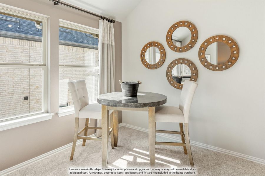 Small dining nook with round table, two white chairs, and four circular wood-framed mirrors on the wall. Small dining nook with round table, two white chairs, and four circular wood-framed mirrors on the wall.