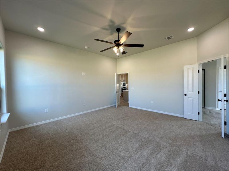 Carpeted spare room featuring recessed lighting and a ceiling fan