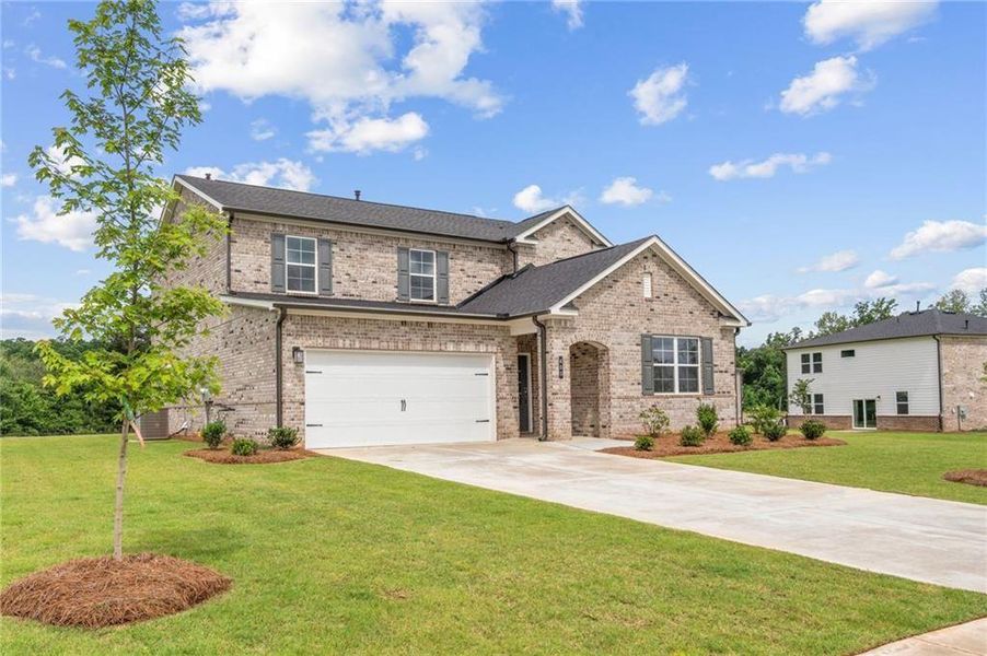 Front exterior of a new home in Walker Grove, McDonough, GA, highlighting curb appeal (Image 21). Front exterior of a new home in Walker Grove, McDonough, GA, highlighting curb appeal (Image 21).