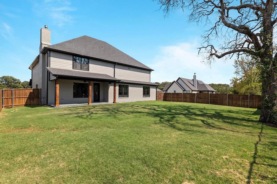 Rear view of property featuring a lawn