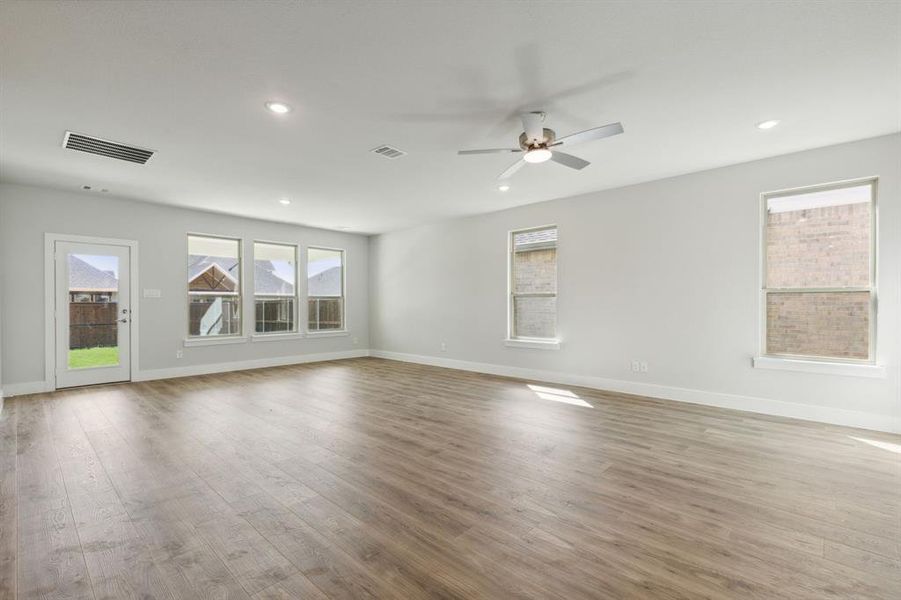 Spare room with ceiling fan and light wood-type flooring