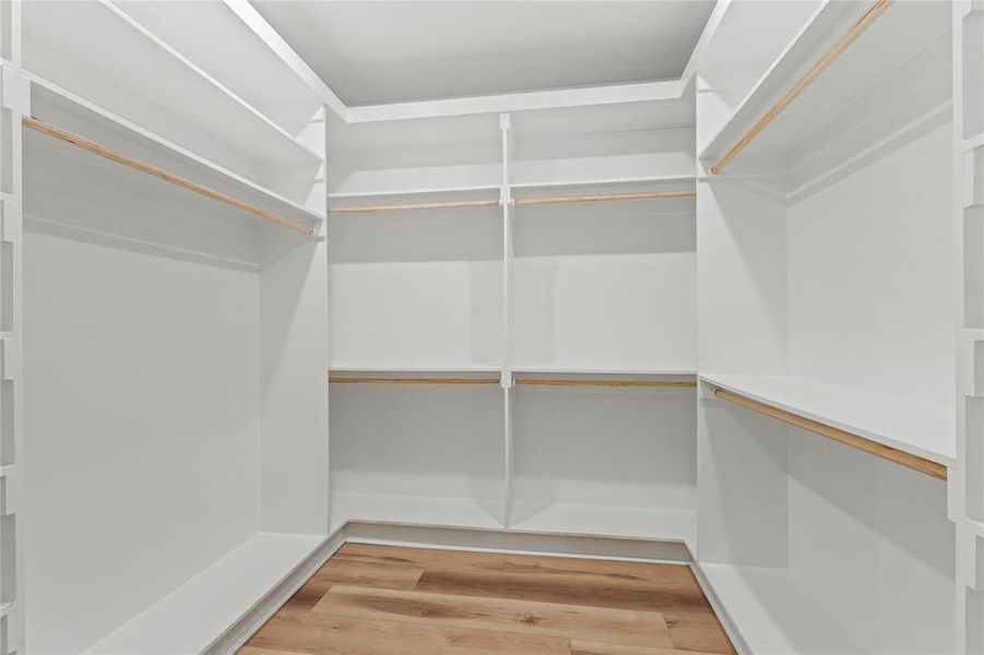 Spacious closet with light wood finished floors Spacious closet with light wood finished floors
